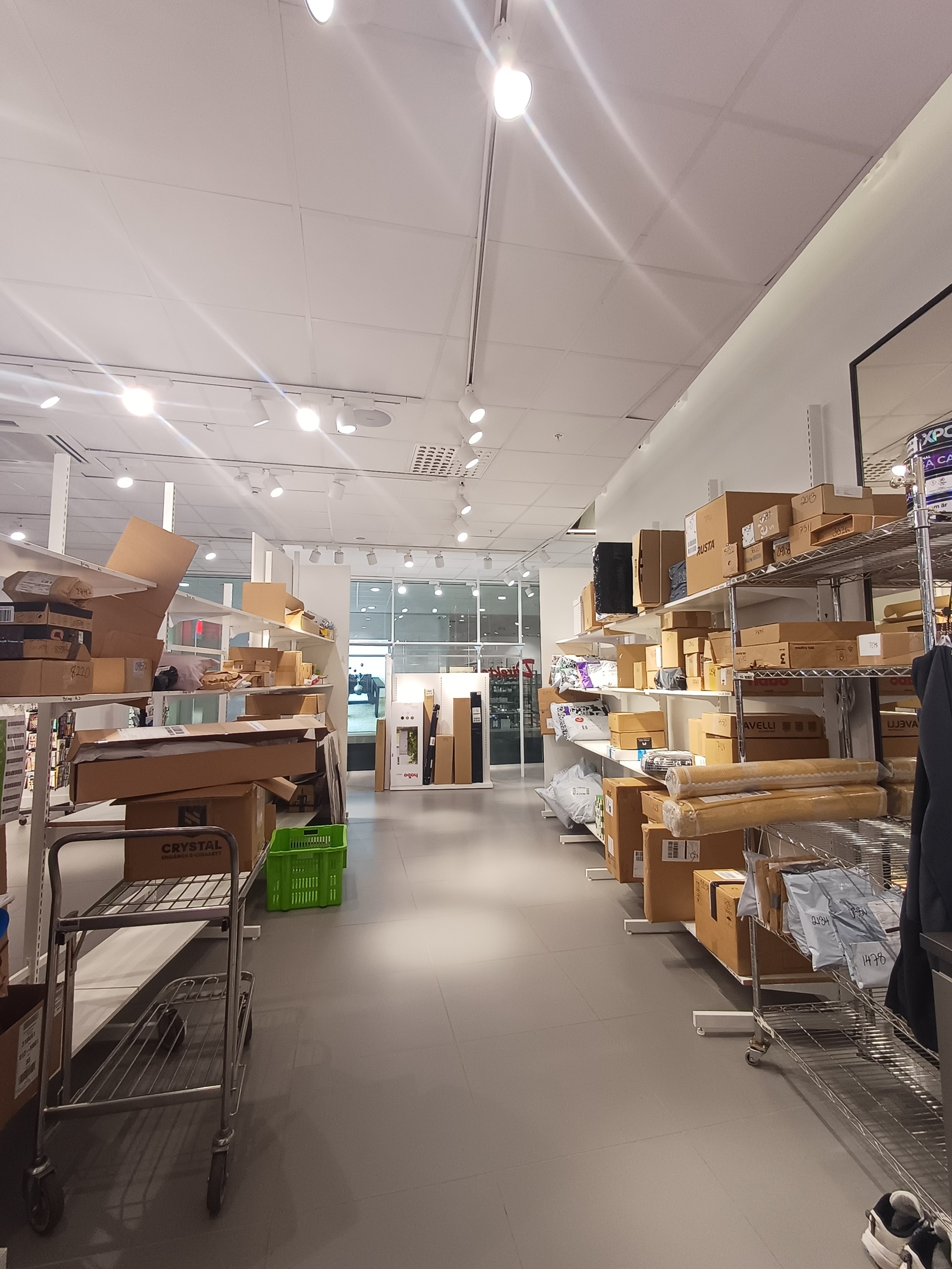 Clothing Store Checkout Cashier Counter: Female Retail Sales Manager Explaining to New Male Assistant Employee Everything He Needs to Know About Working at Fashionable Shop with Stylish Brand Designs.